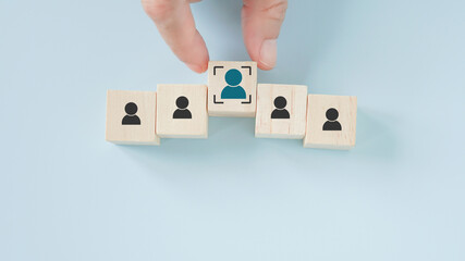 businessman's hand choose person  in focus icon on wooden cube block  for buyer persona and target...