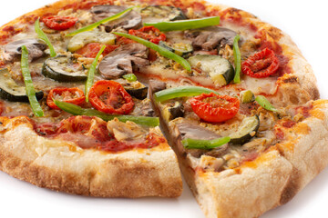 Vegetarian pizza with zucchini, tomato, peppers and mushrooms isolated on white background. Close up