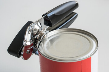 Tin opener opening a can in a kitchen. - 508414127