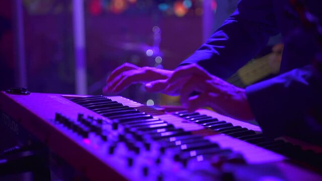 Electric piano, Actor playing on the keyboard synthesizer piano keys. Musician plays a musical instrument on the concert stage. synthesizer, press the keys, man, artist, note. FullHD footage