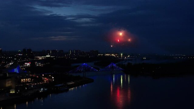 
Festive fireworks in the city on the river, aerial shot, at night
