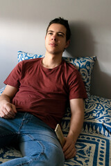 Obraz premium Teenager lying in bed for thoughtful gesture