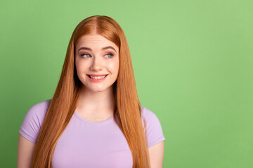 Photo of young cheerful lady look empty space minded thoughtful creative isolated over green color background