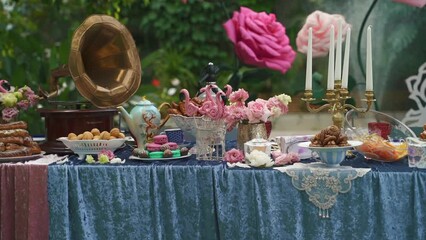 Decor in the style of Alice in Wonderland.Festive table decoration wedding banquet.Interior of a wedding hall decoration ready for guests.Beautiful room for ceremonies and weddings.Wedding concept. 