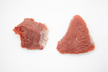 Raw beef meat over on white background, top view, beef steak pieces