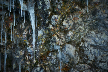 Icicles on the rock. Frozen waterfall in winter.