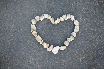 The heart of stones on asphalt