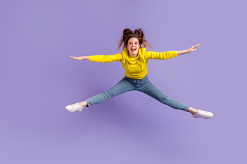 Obraz premium Full length photo of young girl have fun jump up sportive wear modern outfit isolated over purple color background