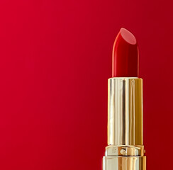 Red lipstick in golden tube on colour background, luxury make-up and cosmetics for beauty brand...