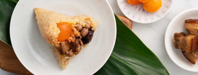 Zongzi. Rice dumpling for Dragon Boat Festival on bright marble table background with ingredient.