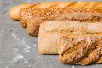 Homemade natural breads. Different kinds of fresh bread as background, perspective view with copy space