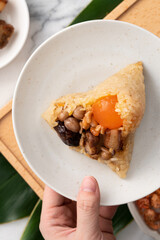 Zongzi. Rice dumpling for Dragon Boat Festival on bright marble table background with ingredient.