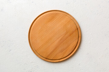 Top view of wooden cutting board on cement background. Empty space for your design