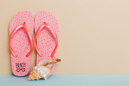 Beach accessories. Flip flops and starfish on colored background. Mock up with copy space