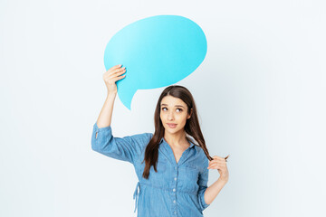 Doubting brunette girl with empty speech bubble