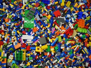 Lots of colorful Bricks pieces. Bricks background. Selective focus.