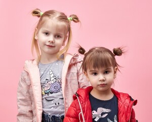 sister's children in a jacket on a pink background.