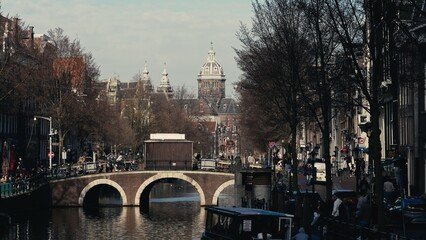 Canal in Amsterdam, with the Basilica of st Nicholas in the background