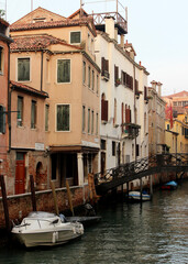 Fototapeta na wymiar Venice canal view. Colorful facades, boats, calm river water. Beautiful architecture of Italy. Most romantic travel destinations. 