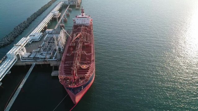 Aerial view of a tanker is loading in oil berth harbour terminal.