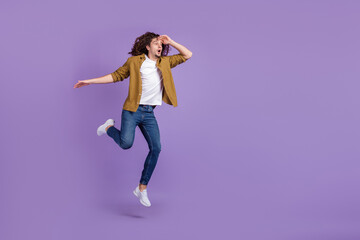 Full body profile side photo of young guy amazed shock look empty space jumper isolated over purple color background