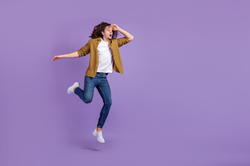 Full body profile side photo of young guy amazed shock look empty space jumper isolated over purple...