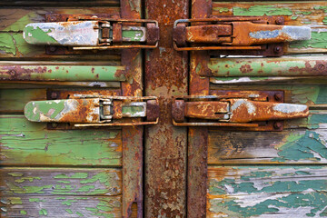 Rusting metal latch locks on wood truckbed