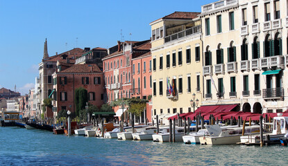 Fototapeta na wymiar Beautiful city view of Venice Canals, Streets and Monuments. Colorful buildings near water. Sunny day in Italy. Tourist destinations concept. 