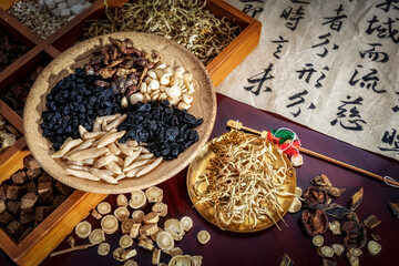 Chinese herbal medicine and flower tea on wooden