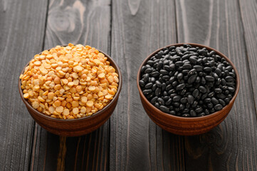 Fresh organic natural beans and peas on wooden rustic black background