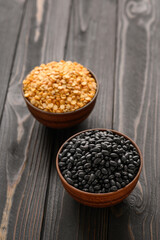 Fototapeta na wymiar Fresh organic natural beans and peas on wooden rustic black background
