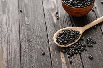 Fresh organic natural beans on wooden rustic black background