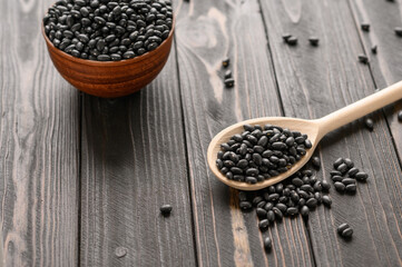 Fresh organic natural beans on wooden rustic black background