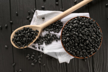 Fresh organic natural beans on wooden rustic black background
