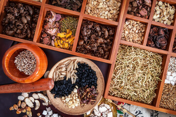 Chinese herbal medicine and flower tea on wooden