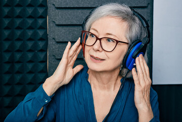 Hearing test at senior woman. Gray-haired mature woman during hearing exam and audiometry at hearing clinic