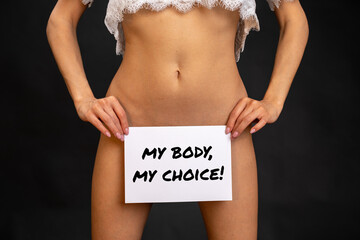young woman holds a my-body-my-choice-sign