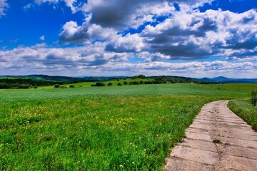 panorama of the beautiful landscape of the Czech Republic. sunny afternoon. Wonderful spring landscape. grass field and hills. rural scenery