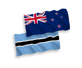National vector fabric wave flags of New Zealand and Botswana isolated on white background. 1 to 2 proportion.