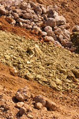 Accumulation of very dry earth with earthy colors, predominantly ocher and pink.