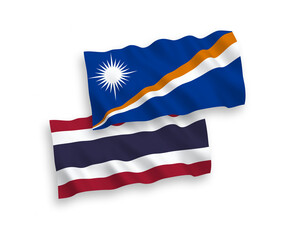 National vector fabric wave flags of Republic of the Marshall Islands and Thailand isolated on white background. 1 to 2 proportion.
