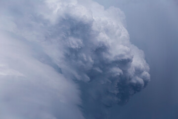 puffs of rain clouds swirling into a whirlwind, before a thunderstorm