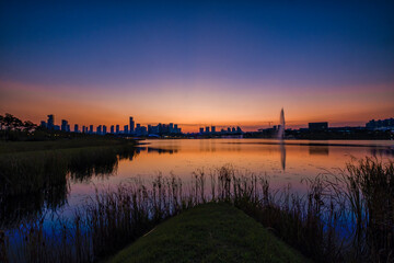 Fototapeta premium Scenic view of Sejong Lake Park against sky during sunset