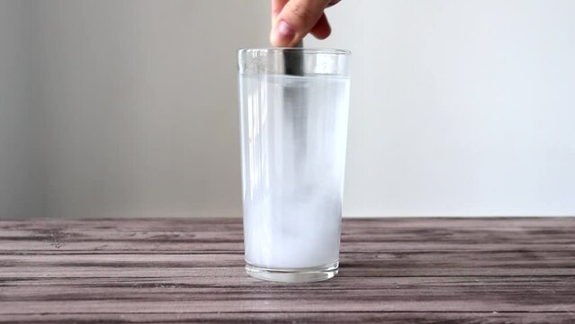 Adding a spoonful of baking soda to the water. The medicine dissolved in warm water.