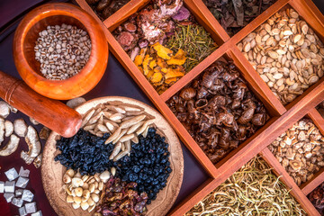 Chinese herbal medicine and flower tea on wooden
