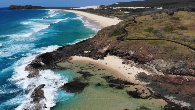 Bird eye view of naturally created pools in the Australian coastline in paradise