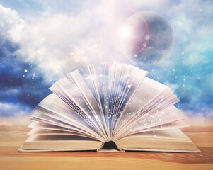 Open book with glitter overlay and beautiful sky on background