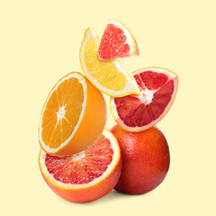 Fresh juicy citrus fruits on beige background