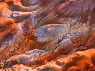 Red colorful mountains, abstract nature background. Aerial top down view. Kyzyl-Chin valley, also called as Mars valley in Altai, Siberia, Russia. - obrazy, fototapety, plakaty
