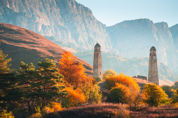 Old stone tower complex in Erzi national park in Ingushetia, Caucasus, Russia. Beautiful autumn landscape at sunrise.